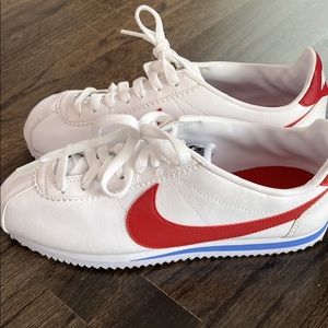 Nike white sneakers with red swoosh. Worn once so mint condition.